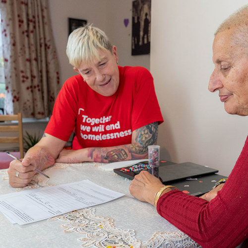 two women work on paperwork together